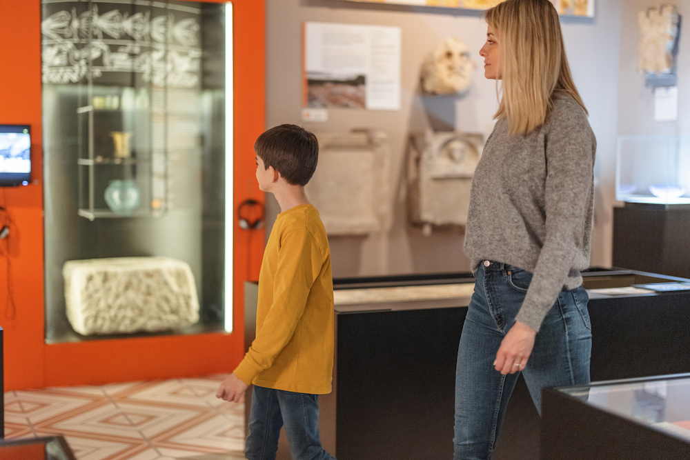 mother and son looking at a museum exhibit